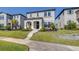 Charming two-story home featuring a well-manicured lawn and inviting front entrance, flanked by lush landscaping at 13319 Dorado Shores Ave, Riverview, FL 33579