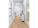 Bright hallway with wood floors, arched doorway, natural light, and view to a bedroom at 13319 Dorado Shores Ave, Riverview, FL 33579