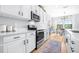 Well-equipped kitchen featuring stainless steel appliances, white cabinetry, and a cozy breakfast nook with lots of natural light at 13319 Dorado Shores Ave, Riverview, FL 33579