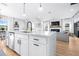 Open-concept kitchen with a large island, modern finishes, and seamless flow into the living area at 13319 Dorado Shores Ave, Riverview, FL 33579