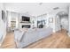 Spacious living room with a cozy fireplace, hardwood floors, and large windows that provide plenty of natural light at 13319 Dorado Shores Ave, Riverview, FL 33579