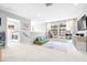 Spacious upstairs loft area featuring a play area, seating and laundry room at 13319 Dorado Shores Ave, Riverview, FL 33579