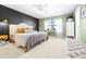 Comfortable main bedroom featuring stylish accent wall, natural light, and neutral carpet at 13319 Dorado Shores Ave, Riverview, FL 33579