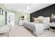 Bright main bedroom with views to bathroom; features stylish furnishings and calming color palette at 13319 Dorado Shores Ave, Riverview, FL 33579