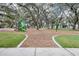 Playground with mature trees providing shade and a variety of play equipment for children at 13319 Dorado Shores Ave, Riverview, FL 33579