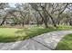Community playground featuring mature trees, walking paths, and play equipment at 13319 Dorado Shores Ave, Riverview, FL 33579