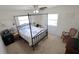 Comfortable bedroom with a four-poster bed, two windows, and carpeted floors for a cozy atmosphere at 1345 Springdale St, Clearwater, FL 33755