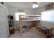 Bright bedroom featuring a wooden loft bed, neutral walls, and a ceiling fan for comfortable living at 1345 Springdale St, Clearwater, FL 33755