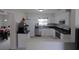 Well-lit kitchen with white cabinets, stainless steel appliances, and dark countertops at 1345 Springdale St, Clearwater, FL 33755