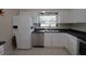 Bright kitchen features white cabinetry, stainless steel dishwasher, and a large window over the sink at 1345 Springdale St, Clearwater, FL 33755