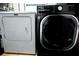 Modern laundry area with a front-load washing machine and dryer for convenient chores at 1345 Springdale St, Clearwater, FL 33755