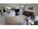 Cozy living room with carpeted floors, comfortable seating, and an adjacent kitchen with stainless appliances at 1345 Springdale St, Clearwater, FL 33755