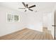 Bright bedroom with hardwood floors, a ceiling fan, and a window with natural light at 1410 San Charles Dr, Dunedin, FL 34698