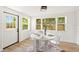 Dining room featuring a modern table, transparent chairs, and bright natural light at 1410 San Charles Dr, Dunedin, FL 34698