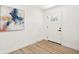 Bright entryway with light wood floors, white walls, and front door with nine glass panes at 1410 San Charles Dr, Dunedin, FL 34698
