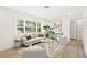 Bright living room features a large window and contemporary furnishings, creating a welcoming and airy atmosphere at 1410 San Charles Dr, Dunedin, FL 34698