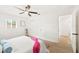 Comfortable bedroom with ceiling fan and spacious closet at 1410 San Charles Dr, Dunedin, FL 34698