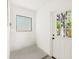 Mud room with a concrete floor, a door to the backyard, and a window for natural light at 1410 San Charles Dr, Dunedin, FL 34698