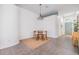 Bright dining area with a wooden table, four chairs, and natural light from the front door at 1419 Trail Boss Ln, Brandon, FL 33511
