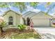 Beautiful single-story home with lush landscaping and a well-manicured lawn at 1419 Trail Boss Ln, Brandon, FL 33511