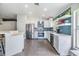 Modern kitchen with stainless steel appliances, an island with bar seating, and tile floors at 1419 Trail Boss Ln, Brandon, FL 33511