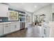 Bright kitchen featuring stainless steel appliances, a blue backsplash, and a sliding door to the patio at 1419 Trail Boss Ln, Brandon, FL 33511