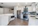 Modern kitchen with stainless steel appliances, quartz countertops, and a stylish blue backsplash at 1419 Trail Boss Ln, Brandon, FL 33511