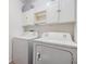 Functional laundry area equipped with washer, dryer, and ample storage space at 1419 Trail Boss Ln, Brandon, FL 33511