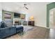 This living room has tile floors, a fireplace, large windows, and a comfortable blue sofa at 1419 Trail Boss Ln, Brandon, FL 33511