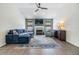 Inviting living room featuring a fireplace, large windows, and a comfortable blue sofa at 1419 Trail Boss Ln, Brandon, FL 33511