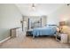 Calm main bedroom with a view of the pool, a blue bed, and a light dresser at 1419 Trail Boss Ln, Brandon, FL 33511