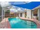 Inviting pool area featuring brick trim and a screened enclosure for outdoor enjoyment at 1419 Trail Boss Ln, Brandon, FL 33511