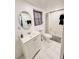Bathroom featuring a shower, a white vanity with mirror and sink, and white tiled flooring at 1515 E 31St Ave, Tampa, FL 33610