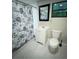 Clean bathroom with a vanity, toilet, decorative shower curtain, and a window at 1515 E 31St Ave, Tampa, FL 33610