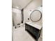 Bathroom featuring a vanity with a round mirror above, shower, toilet, and white tiled floors at 1515 E 31St Ave, Tampa, FL 33610