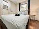 Well-lit bedroom featuring a comfortable bed, side table, and window for natural light at 1515 E 31St Ave, Tampa, FL 33610