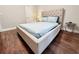 Cozy bedroom featuring a tufted headboard bed with hardwood floors at 1515 E 31St Ave, Tampa, FL 33610