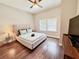Inviting bedroom with a tufted headboard bed, a ceiling fan, and natural light at 1515 E 31St Ave, Tampa, FL 33610