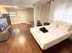 Cozy bedroom featuring a queen bed, hardwood floors, and a mounted TV at 1515 E 31St Ave, Tampa, FL 33610