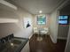 Bright dining area featuring a glass table, chairs, and natural light from the window at 1515 E 31St Ave, Tampa, FL 33610