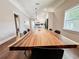 Dining room with a long, natural wood table and modern black chairs at 1515 E 31St Ave, Tampa, FL 33610