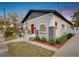 Charming home featuring a red door, landscaped yard, flower boxes, and an American flag at 1515 E 31St Ave, Tampa, FL 33610