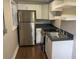 A modern kitchen with stainless steel appliances, white cabinets, and dark countertops at 1515 E 31St Ave, Tampa, FL 33610