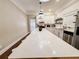 Bright kitchen with white cabinets, quartz countertops, stainless appliances and large island with seating at 1515 E 31St Ave, Tampa, FL 33610