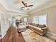Open-concept living room and kitchen area featuring a plush sofa and hardwood flooring at 1515 E 31St Ave, Tampa, FL 33610
