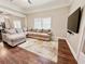 Comfortable living room featuring a sectional sofa, decorative rug, and a mounted television at 1515 E 31St Ave, Tampa, FL 33610