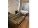 Inviting living room featuring a modern sofa and a partial view of the bedroom area at 1515 E 31St Ave, Tampa, FL 33610