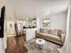 Inviting living space with a comfortable sofa, flat-screen TV, and a modern kitchen view at 1515 E 31St Ave, Tampa, FL 33610