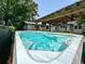Relaxing spa with clear blue water, surrounded by a well-maintained backyard and lush greenery at 1515 E 31St Ave, Tampa, FL 33610