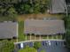 Aerial shot showcasing the property, landscaping, parking, and surrounding trees at 15733 Fishhawk Falls Dr, Lithia, FL 33547
